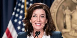 You Won’t Believe Who NY Gov Blames for NY Antisemitism woman speaking at a podium with microphones