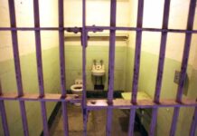 Rikers Slip Sparks $1M Payout Push Interior of a prison cell with a toilet, sink, and metal bars