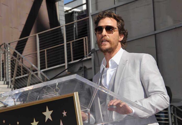 Matthew McConaughey speaking at a podium outdoors