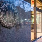 FBI-NYPD Unmask Hamas Cash Pipeline FBI emblem on a stone wall beside a glass entrance