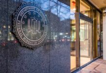 FBI-NYPD Unmask Hamas Cash Pipeline FBI emblem on a stone wall beside a glass entrance
