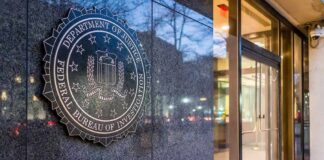 FBI-NYPD Unmask Hamas Cash Pipeline FBI emblem on a stone wall beside a glass entrance