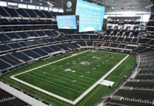 American football stadium interior with large central video board