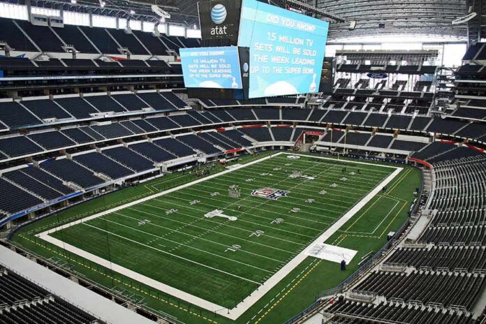 shutterstock_70024276 American football stadium interior with large central video board